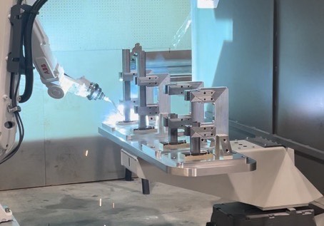 ABB welding robot in a precision fixturing cell at United Robotics